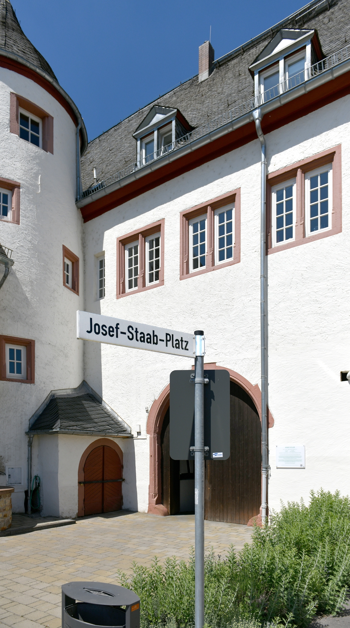 Josef-Staab-Platz mit Blick auf das Kiedricher Rathaus, einem weissen Gebäude mit sandsteinfarbenen Fensterrahmen